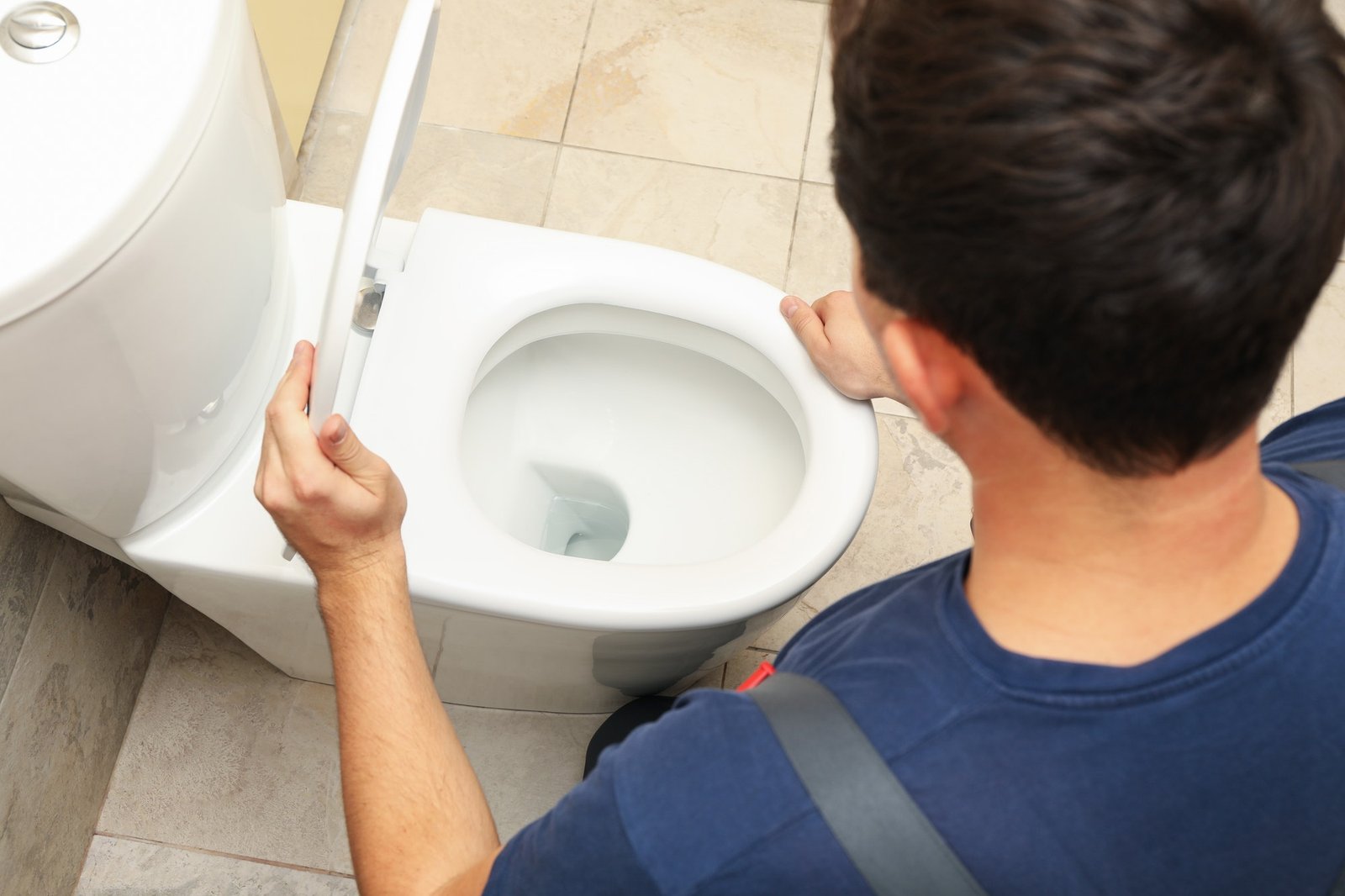 the-plumber-in-overalls-fixes-the-toilet.jpg
